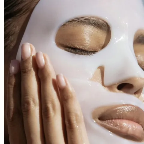 Woman removing collagen mask